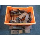 A crate containing antique woodworking planes, block planes etc.