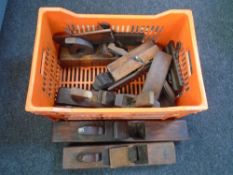 A crate containing antique woodworking planes, block planes etc.