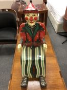 A painted child's armchair in the form of a clown