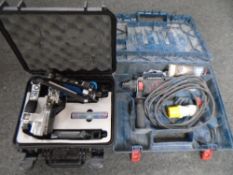 A Bosch 110v hammer drill, cased, together with a PPC Hapi installation tool, cased.