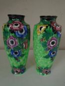 A pair of tall Maling floral lustre vases on green ground, height 24 cm.