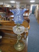 A Victorian brass and glass oil lamp with blue tinted glass shade