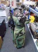 A golf bag containing a set of TaylorMade irons and drivers.