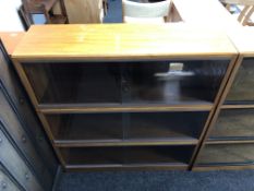 A mid-20th century three tier stacking book case with sliding glass doors (width 91.5cm).