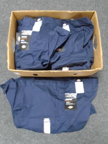 A box containing a quantity of Dickies work trousers