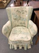 A 20th century armchair upholstered in a peacock patterned fabric