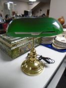 A brass banker's style desk lamp with green glass shade