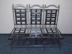 A set of six wrought iron dining chairs.