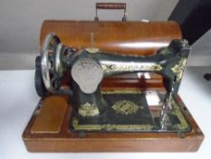 A Singer sewing machine in case.