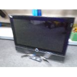 A collection of electricals including monitors, a DVD player, TV with remote control,