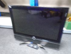 A collection of electricals including monitors, a DVD player, TV with remote control,