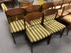 A set of five mid-20th century Danish teak dining chairs upholstered in a striped fabric.