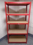 A five tier red metal shelving unit.