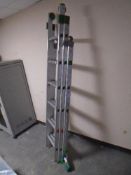 An aluminium triple section extension ladder.