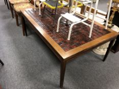 A 20th century Danish tile topped coffee table (length 129cm).