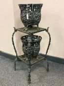 A cast iron two tier plant stand together with two planters (3)
