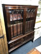 A 20th century continental mahogany double door cabinet on stand, fitted with four drawers.