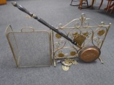 A wrought iron fire screen together with a brass spark guard,