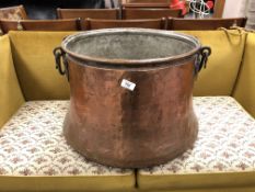A 19th century copper cooking pot with cast iron handle (diameter 48cm).