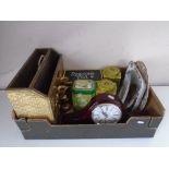 A box containing a brass magazine rack, a pair of candle sticks, a mantel clock, tins etc.