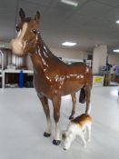 A Beswick figure - Race horse in brown gloss together with a further Beswick fox hound