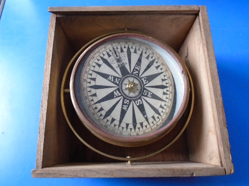 An antique brass ships compass in case