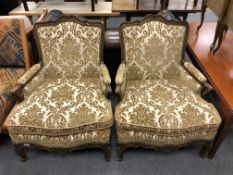 A pair of beech framed Baroque style armchairs in golden brocade