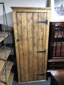 An antique pine single door cupboard.