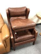 A 20th century Scandinavian leather wingback armchair with footstool, height 103 cm,