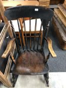 An antique stained beech rocking chair.