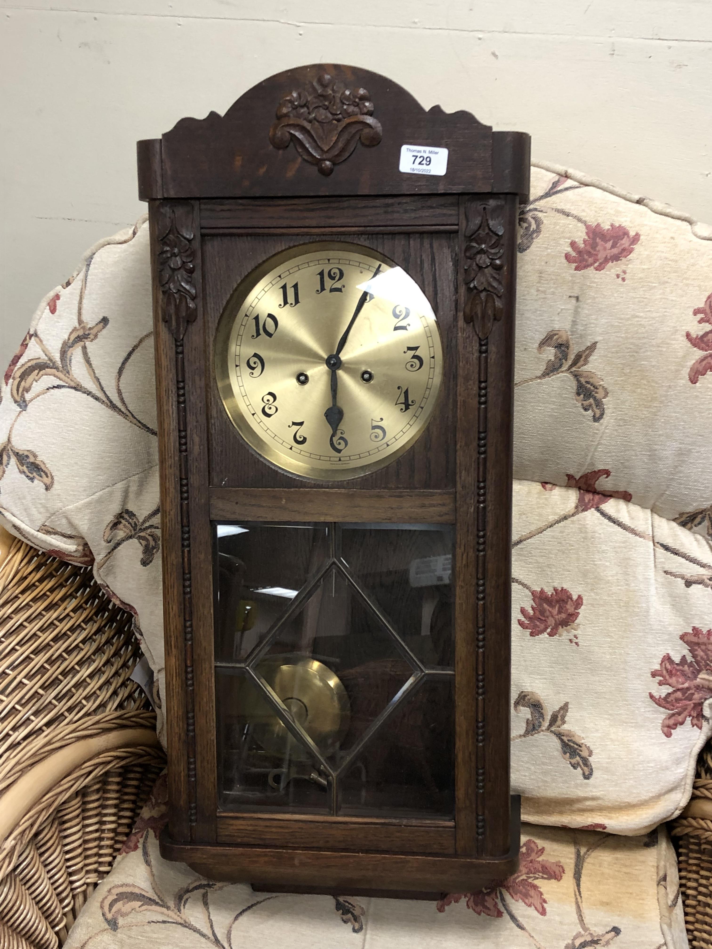 A 20th century oak cased wall clock with brass dial,