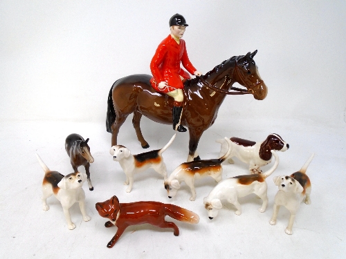 A Beswick huntsman on horse together with five Beswick hounds, Beswick fox,