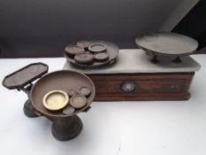 A set of Victorian scales with marble top and weights and a further set of brass scales