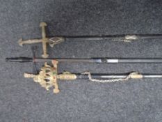 A vintage ceremonial style sword together with two further replica swords in scabbards.