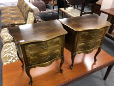 A pair of carved serpentine fronted two drawer chests on cabriole legs