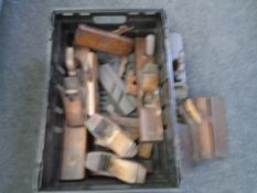 A crate containing antique woodworking planes and block planes.