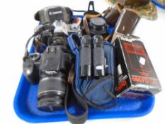 A tray containing cameras and camera accessories including Canon EOS and Canon AV-1,