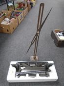 A metal cutter together with a further vintage cast iron metal stand.
