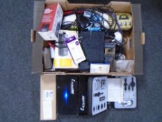 Two boxes containing clock radios, charging cables, Freeview box, professional car speakers,