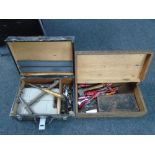 Two wooden tool boxes containing hand tools.