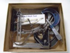 A box containing drawing instruments and callipers etc