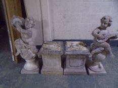 A pair of concrete garden cherub figures on plinths (height 145cm).