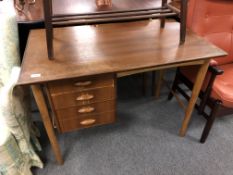 A mid century Danish teak single pedestal desk fitted with four drawers,