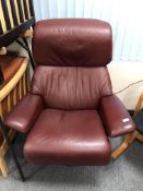 A Stressless Ekornes Burgundy leather swivel armchair