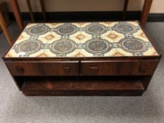 A 20th century Danish rosewood tile topped stand fitted with two drawers (length 84cm).