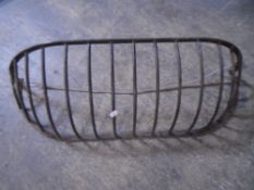 A cast iron wall mounted hay trough.