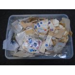 A box containing a large quantity of loose stamps.