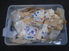 A box containing a large quantity of loose stamps.