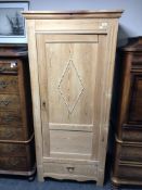 An early 20th century continental pine hall cupboard fitted with a drawer.