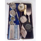 A cased set of fish servers, military pocket compass, bread fork,